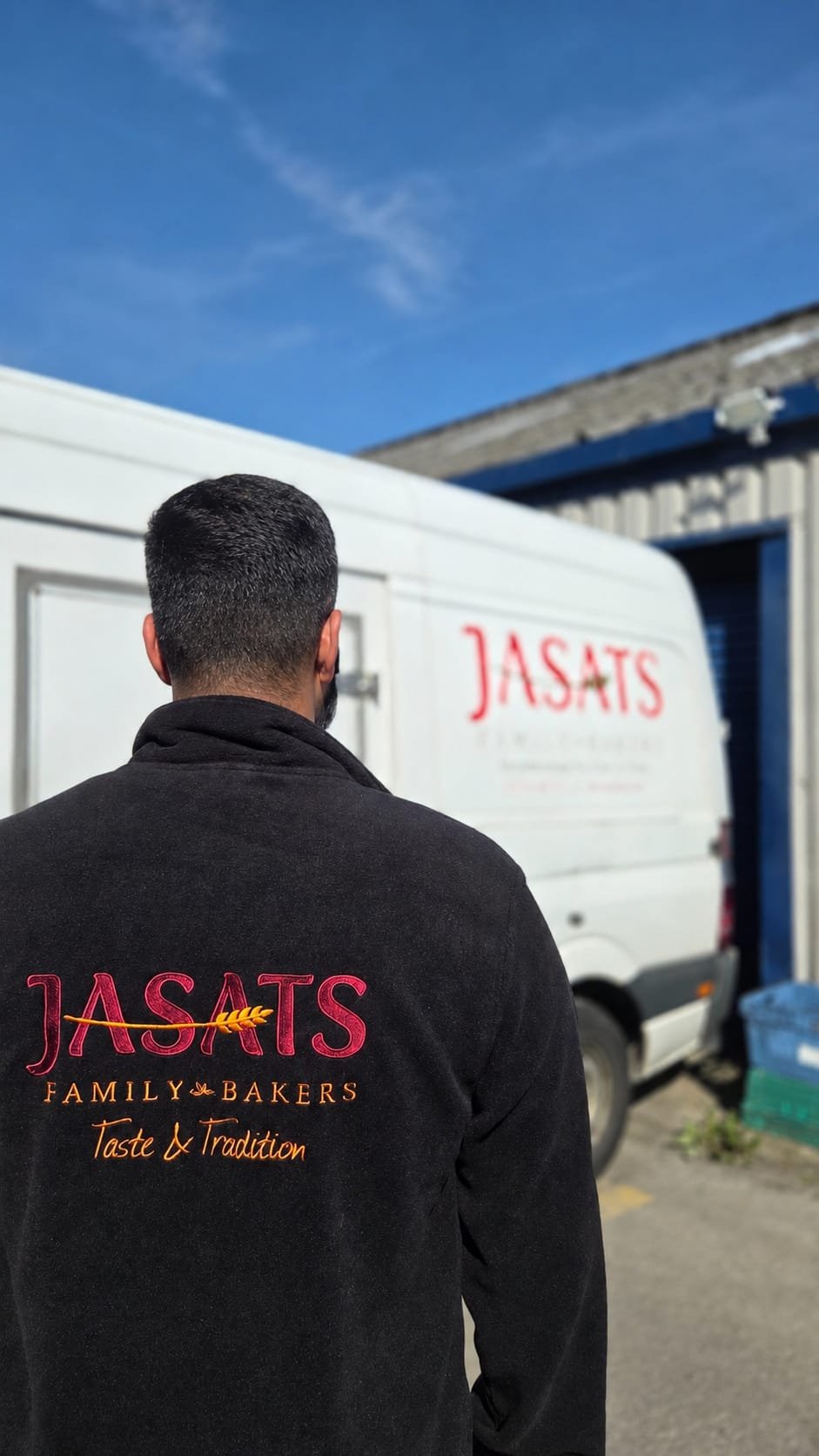 A Jasats team member beside a delivery vehicle